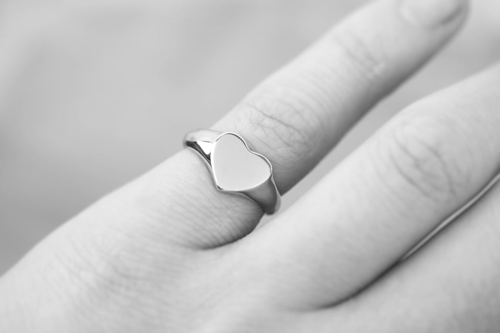 heart signet ring on pinkie finger