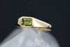 This yellow gold signet ring features a bezel set Emerald Cut Australian Sapphire, in east-west orientation. Perfectly showcasing the unique beauty of Australian sapphires, this one of a kind ring could be worn as an alternative engagement ring, or simply as a cherished everyday ring.