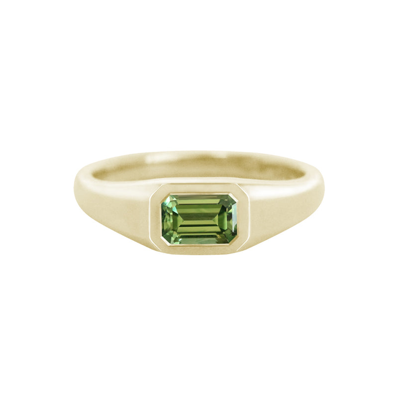 This yellow gold signet ring features a bezel set Emerald Cut Australian Sapphire, in east-west orientation. Perfectly showcasing the unique beauty of Australian sapphires, this one of a kind ring could be worn as an alternative engagement ring, or simply as a cherished everyday ring.