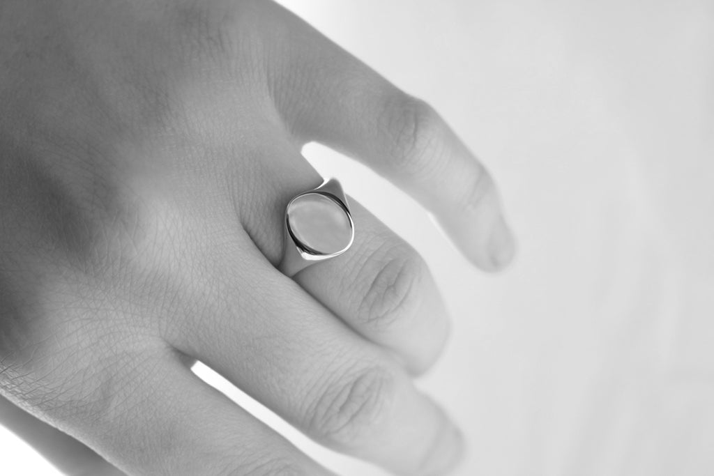 Oval signet ring on hand