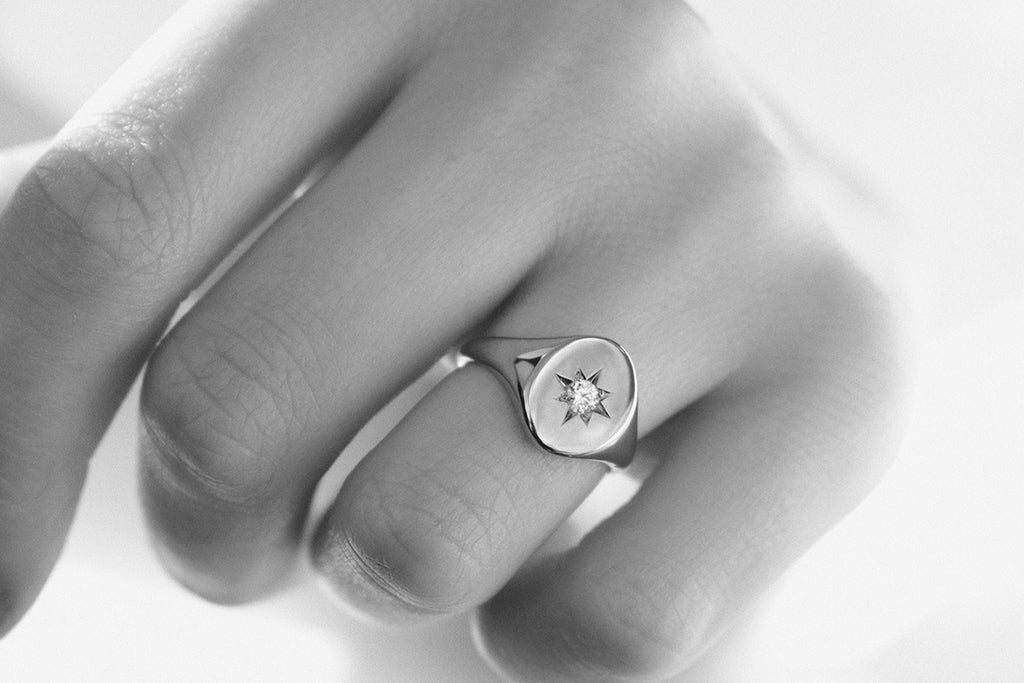 Rose gold signet ring with diamond worn on ring finger